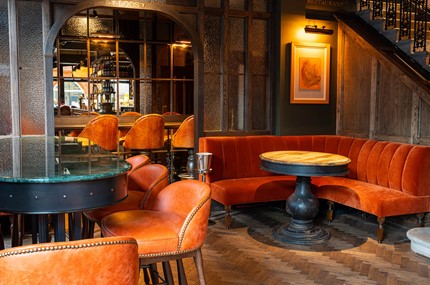Pub with wooden bar and blue bar stools